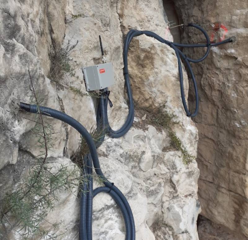 A Worldsensing wireless datalogger connected to a crack meter is used to monitor a rock cliff along the rail line from Lleida to La Pobla in Catalunya, Spain. From Ferrocarrils de la Generalitat de Catalunya (FGC).