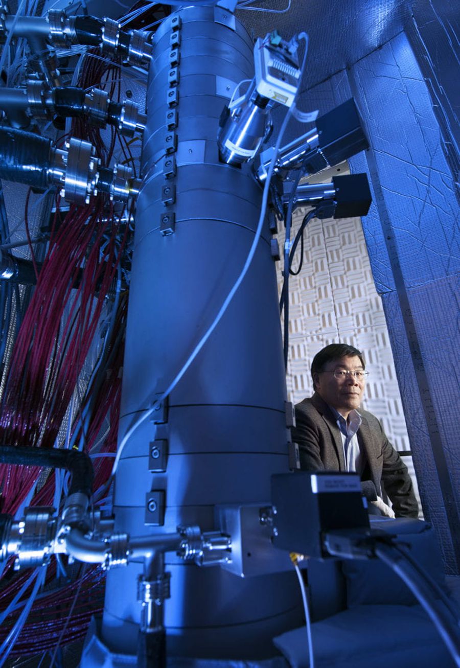 Xiaoqing Pan, UCI professor of materials science and engineering and physics, Henry Samueli Endowed Chair in Engineering, and director of the Irvine Materials Research Institute is seated next to IMRI’s Nion Ultra Scanning Transmission Electron Microscope. The instrument was used to make atomic-scale observations of phonon interactions in crystals, the subject of a new paper in Nature. Credit: Steven Zylius / UCI.