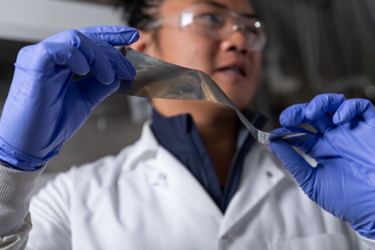 Credit: Georgia Institute of Technology Georgia Tech graduate student researcher Yuhgene Liu holds an aluminum material for solid-state batteries.